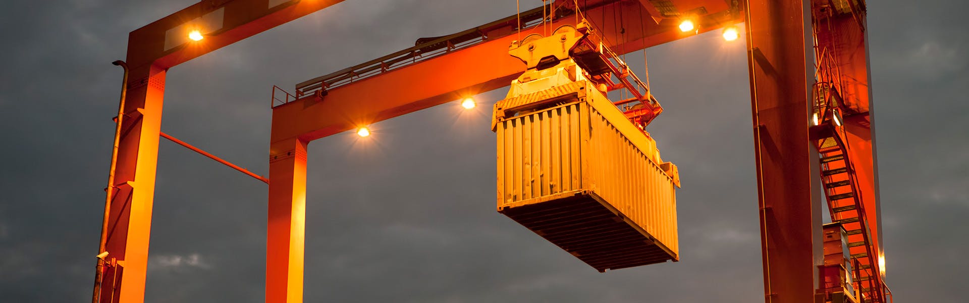 container hoisted crane night dock yard containerized shipping solutions